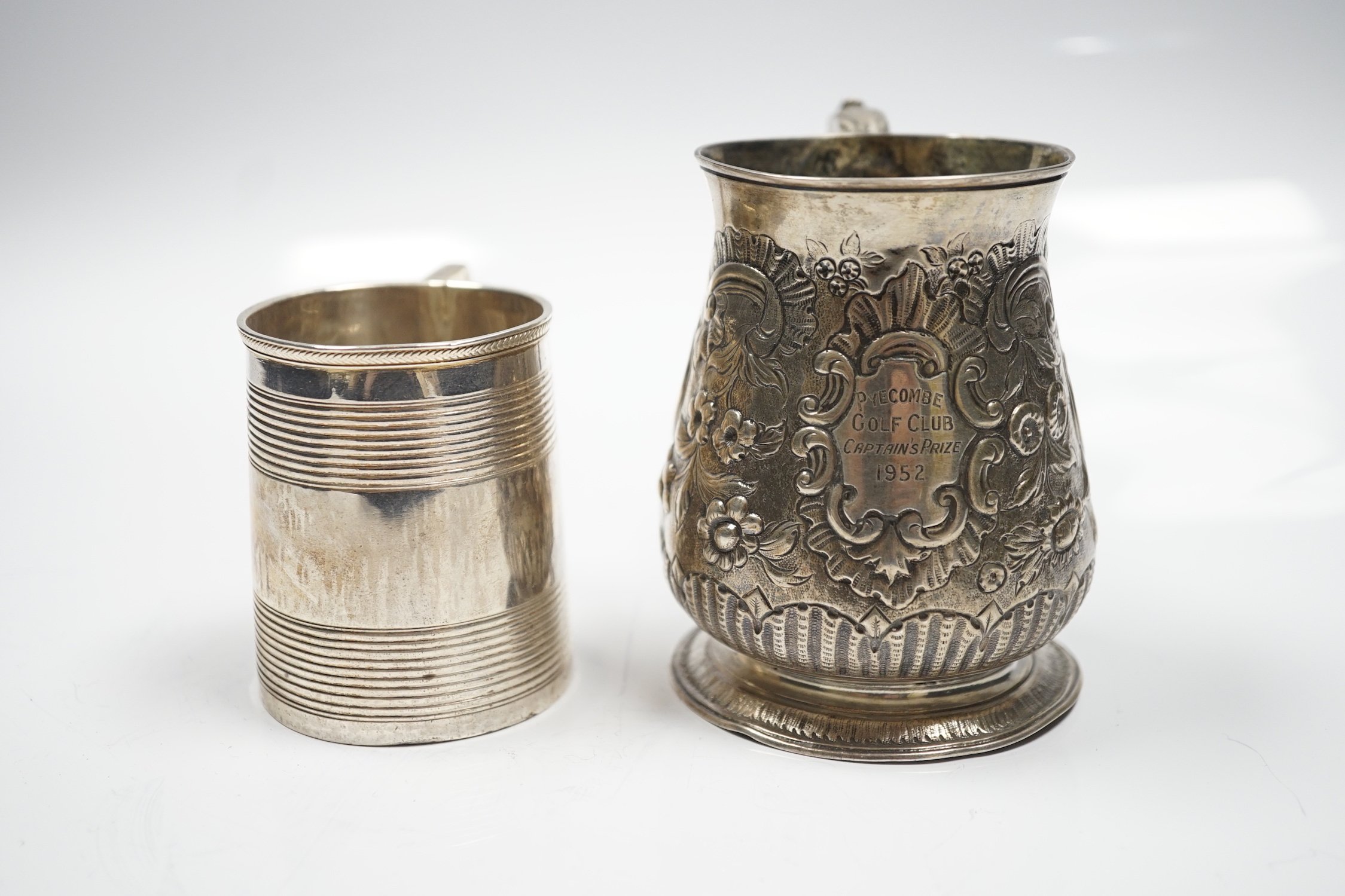 A late George II silver baluster mug, with later embossed decoration, William Shaw II?, London, 1756, 93mm, together with a George III reeded silver small christening mug, London, 1814.